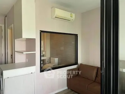 Modern compact living room with air conditioning and brown sofa