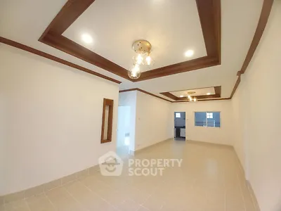 Spacious living room with elegant ceiling lights and tiled flooring