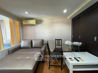 Cozy living room with modern furniture and air conditioning in a stylish apartment.