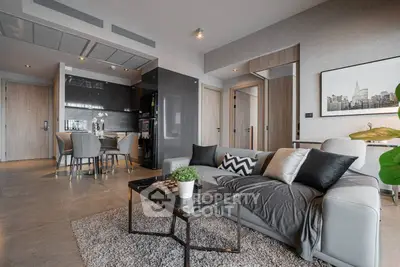 Modern open-plan living room with sleek kitchen and stylish decor