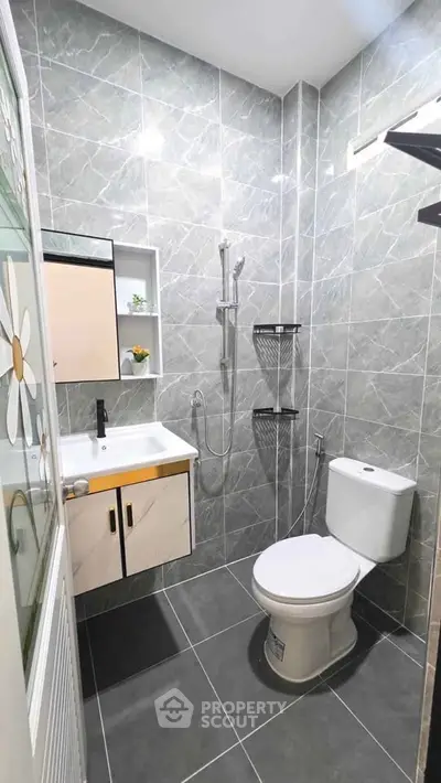 Modern bathroom with sleek gray tiles and contemporary fixtures
