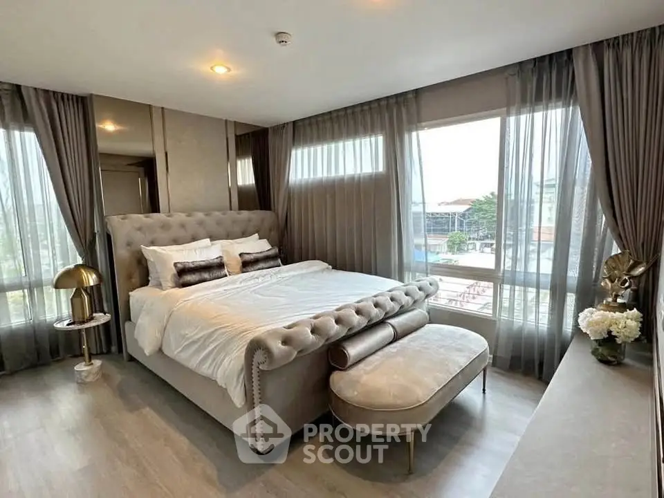 Luxurious bedroom with elegant decor and large windows offering a stunning view, perfect for relaxation.