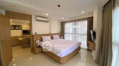 Spacious modern bedroom with natural light and elegant decor