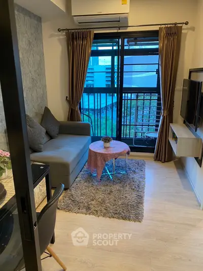 Cozy living room with modern decor and balcony view in urban apartment