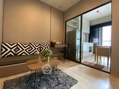 Modern living room with stylish decor and open kitchen layout in a contemporary apartment.