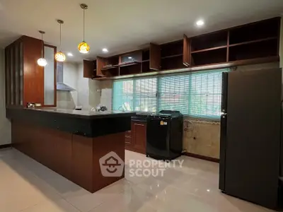 Spacious kitchen with modern appliances and elegant wooden cabinetry