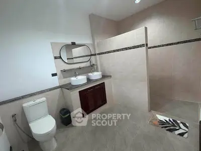 Spacious modern bathroom with dual sinks and walk-in shower