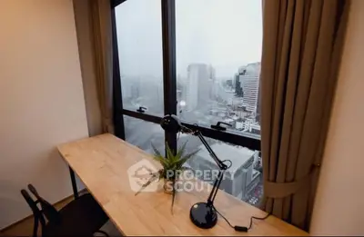 Modern study room with city view, featuring a sleek desk and stylish lamp.