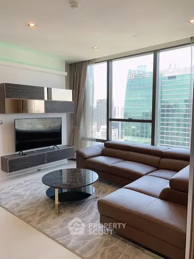 Modern living room with large windows and city view, featuring sleek furniture and contemporary design.