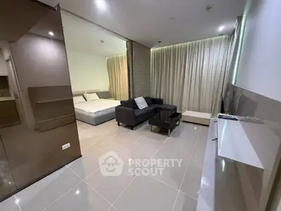 Modern studio apartment with sleek design and open layout, featuring a cozy living area and comfortable bedroom.