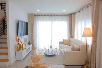 Elegant living room with modern decor and large windows for natural light