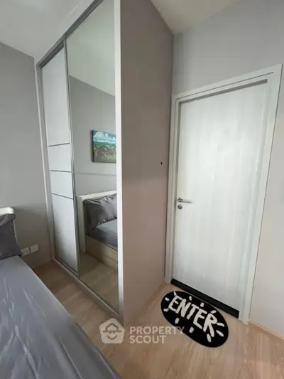 Modern bedroom with sleek sliding wardrobe and cozy decor