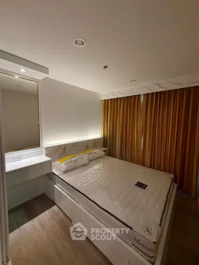 Modern bedroom with elegant lighting and stylish decor, featuring a comfortable bed and sleek furnishings.