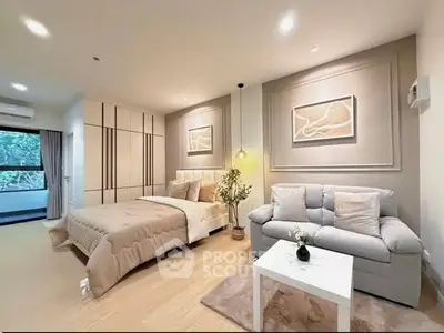 Luxurious bedroom with elegant decor and cozy seating area, perfect for relaxation.