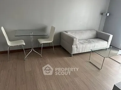Modern minimalist living room with sleek furniture and wooden flooring