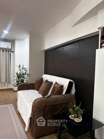 Cozy living room with stylish brown sofa and elegant decor