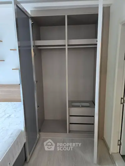 Spacious bedroom with modern wardrobe and sleek wooden flooring