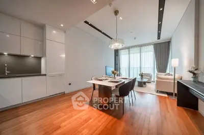 Modern open-plan living and dining area with elegant decor and natural light.