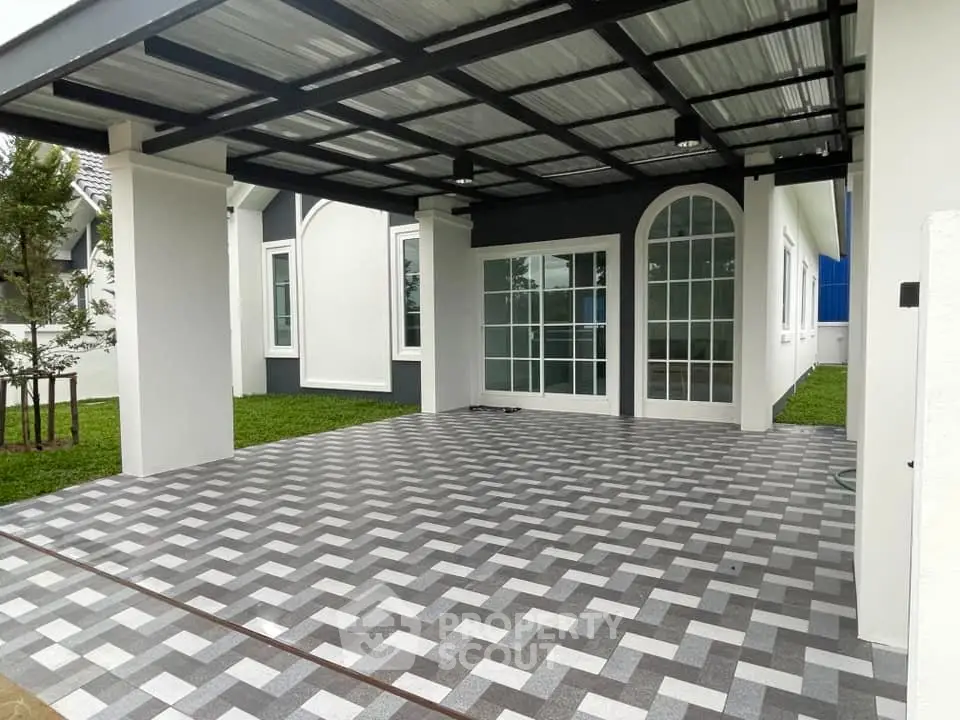 Spacious modern carport with stylish patterned flooring and elegant glass doors.