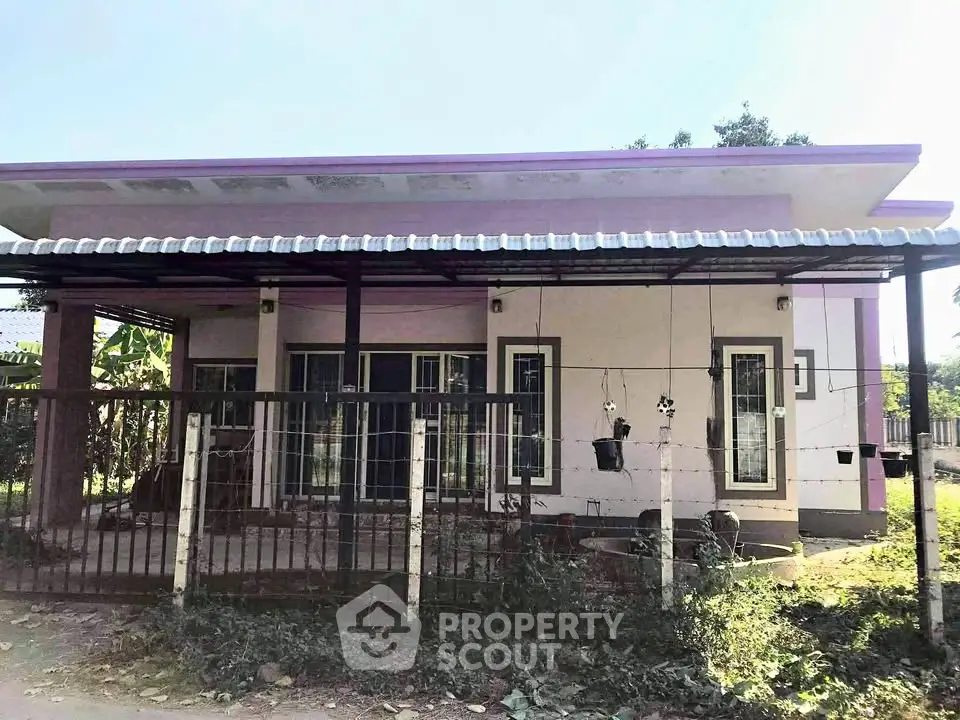 Charming single-story home with a modern flat roof and spacious front yard.