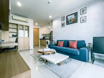 Modern living room with stylish decor and open kitchen layout in a contemporary apartment.