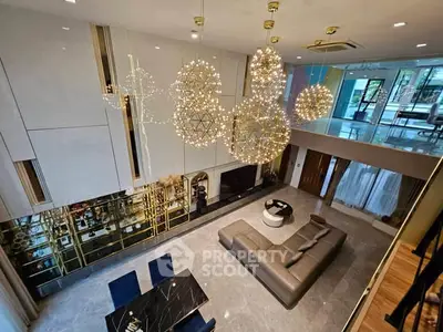 Luxurious modern living room with high ceilings and elegant lighting fixtures