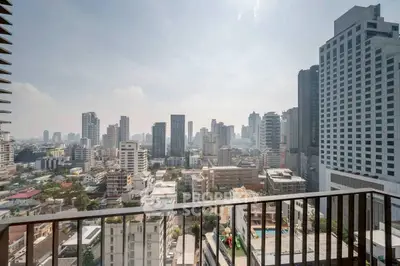 Stunning cityscape view from a high-rise balcony in a bustling urban area.