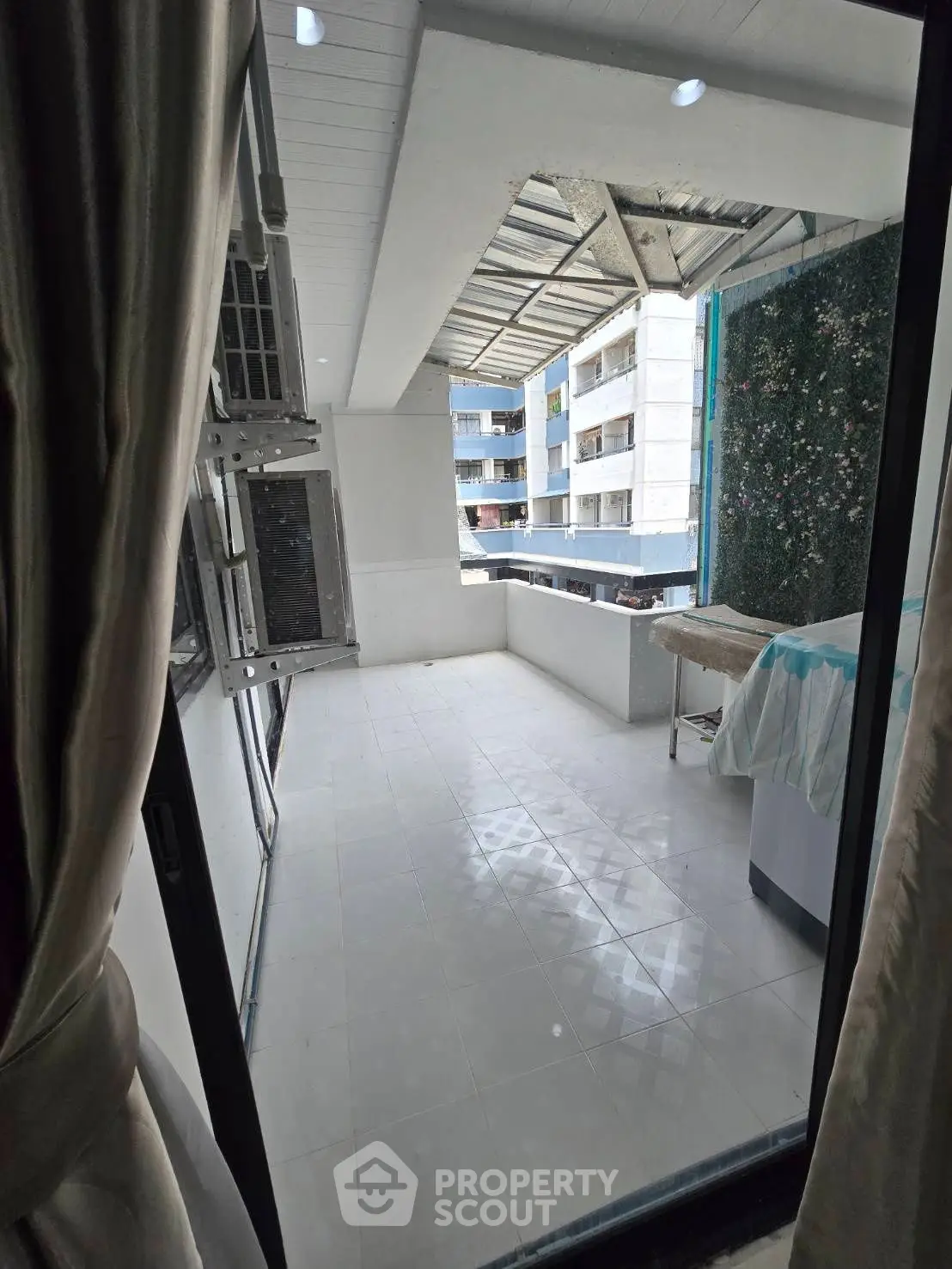 Spacious balcony with modern design and city view, perfect for relaxation and entertainment.