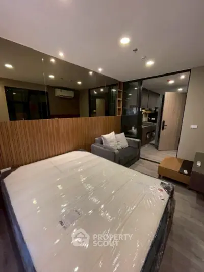 Modern bedroom with cozy sofa and stylish decor, perfect for urban living.