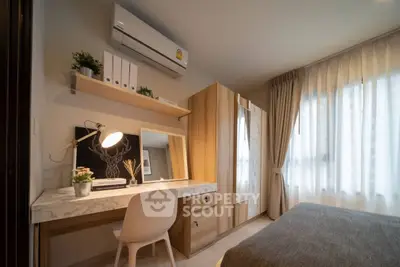 Cozy bedroom with stylish decor and ample natural light