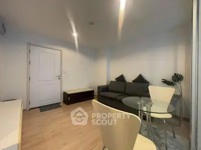 Modern living room with cozy sofa and dining area in a stylish apartment.