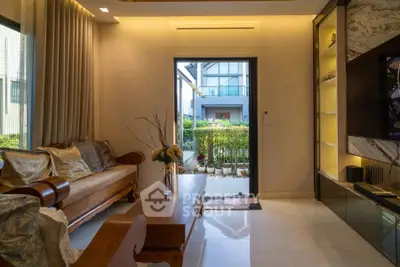 Elegant living room with wooden furniture and garden view, perfect for relaxation and entertaining.
