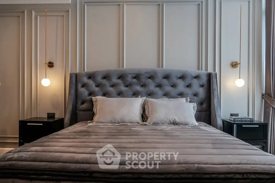 Luxurious bedroom with plush velvet headboard and elegant lighting