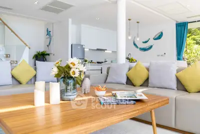 Bright and airy living room with modern decor and open kitchen layout.