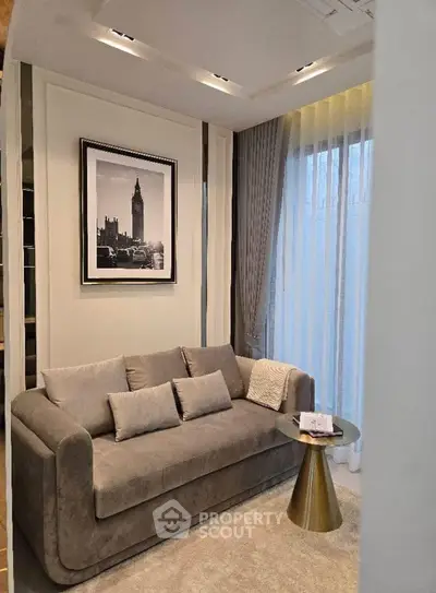 Elegant living room with plush sofa and stylish decor, featuring a framed cityscape art piece.