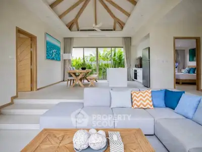 Spacious open-plan living room with modern decor and garden view, perfect for relaxation and entertaining.