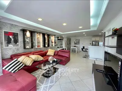 Spacious modern living room with red leather sofas and stylish decor