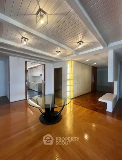 Spacious modern living room with elegant lighting and wooden flooring