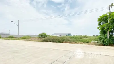 Expansive vacant land with clear skies, ideal for development opportunities.