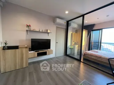 Modern living room with glass partition and balcony view in stylish apartment