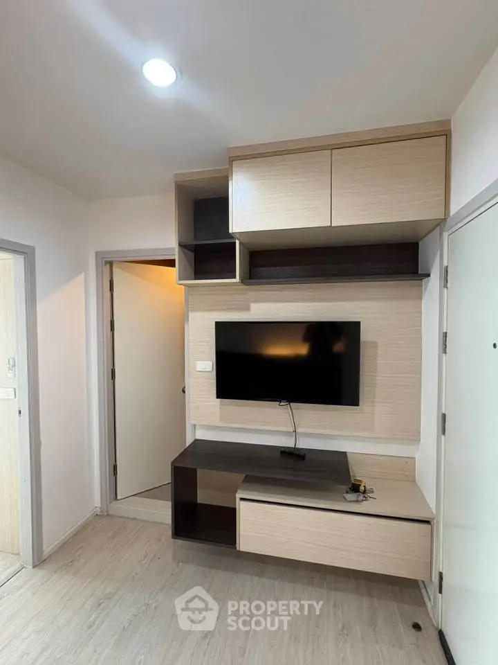 Modern living room with built-in TV unit and sleek storage cabinets