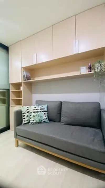 Modern living room with sleek sofa and built-in storage cabinets