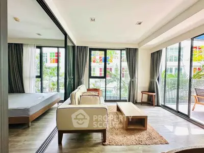 Spacious modern living room with large windows and balcony access in a stylish apartment.