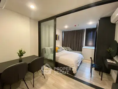 Modern bedroom with sliding glass doors and stylish decor in a contemporary apartment.