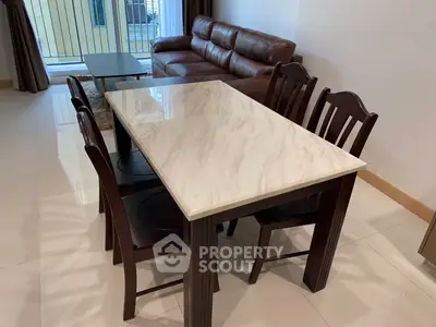 Elegant living room with marble dining table and leather sofa, perfect for modern living.
