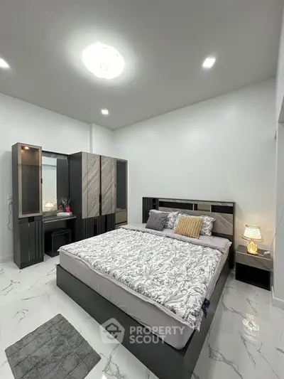 Modern bedroom with sleek furniture and elegant decor, featuring a comfortable bed and stylish wardrobe.