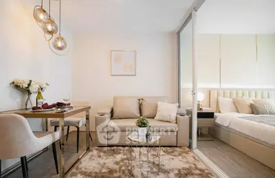 Modern open-plan living room with cozy seating and elegant dining area in stylish apartment.