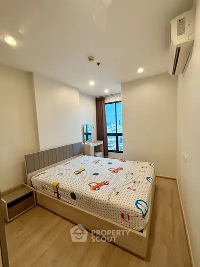 Modern bedroom with city view, featuring stylish decor and ample natural light.