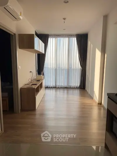 Modern apartment interior with wooden flooring and large window curtains