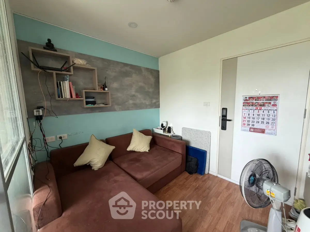 Cozy living room with brown sectional sofa and wall-mounted shelves, perfect for relaxation and reading.